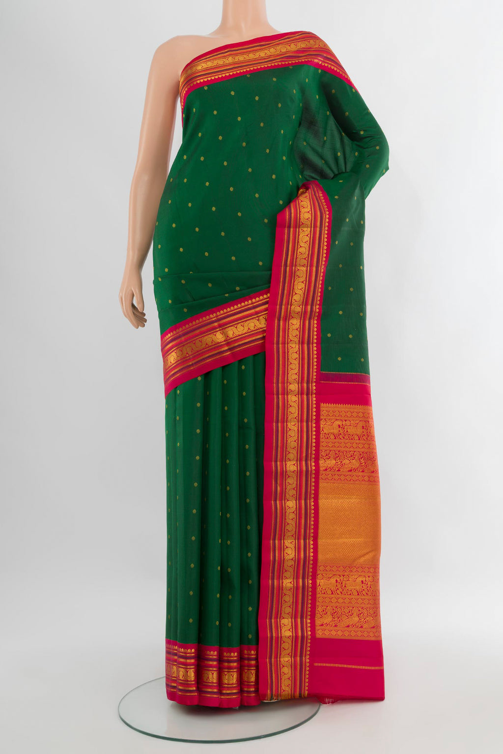 Bottle Green Kanchipuram Silk Saree with Zari Butta on the body and Zari Border.  displayed on a mannequin