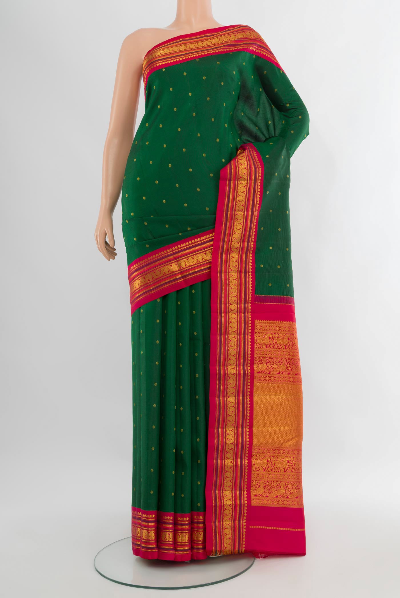 Bottle Green Kanchipuram Silk Saree with Zari Butta on the body and Zari Border.  displayed on a mannequin