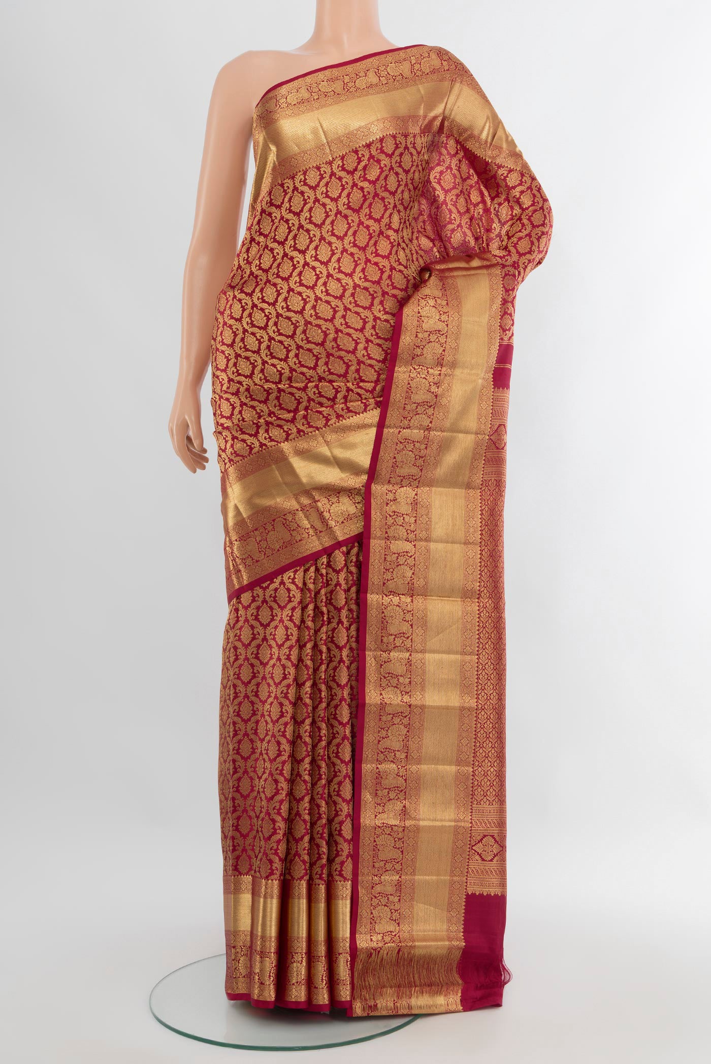 Maroon Kanchipuram Silk Saree with Zari Brocade on the body and Zari Border.  displayed on a mannequin