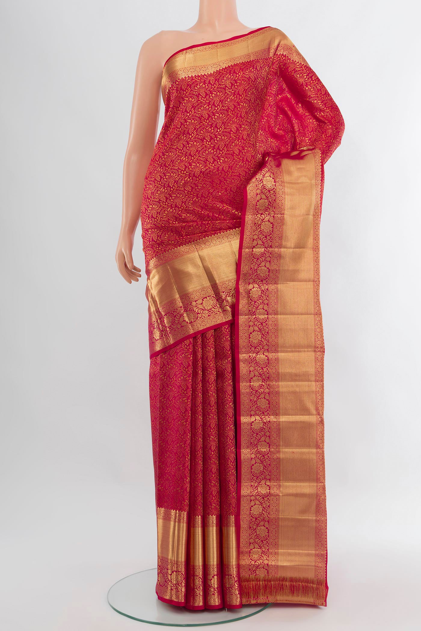 Dark Pink Kanchipuram Silk Saree with Zari Butta on the body and Zari Border.  displayed on a mannequin