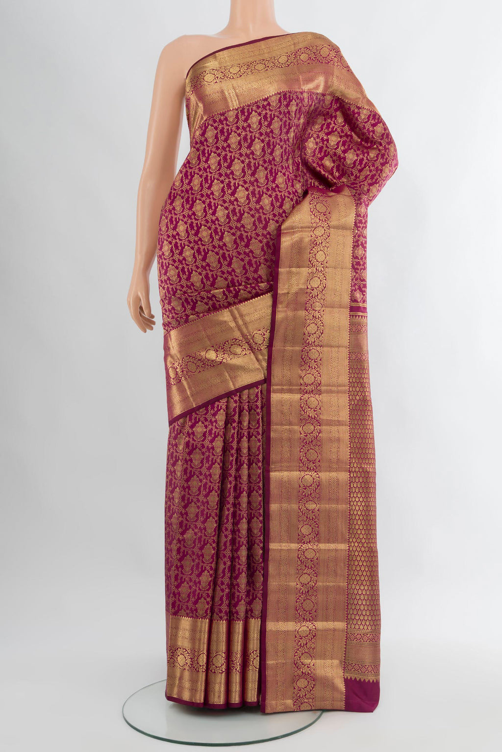 Magenta Kanchipuram Silk Saree with Zari Brocade on the body and Zari Border.  displayed on a mannequin
