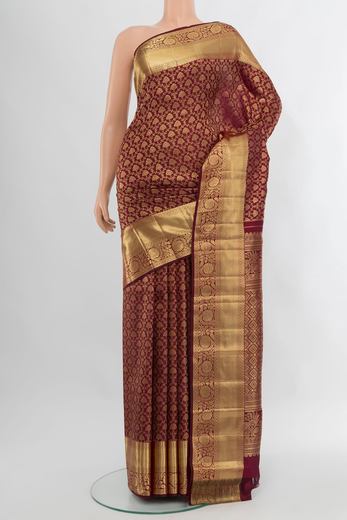 Maroon Kanchipuram Silk Saree with Zari Brocade on the body and Zari Border.  displayed on a mannequin