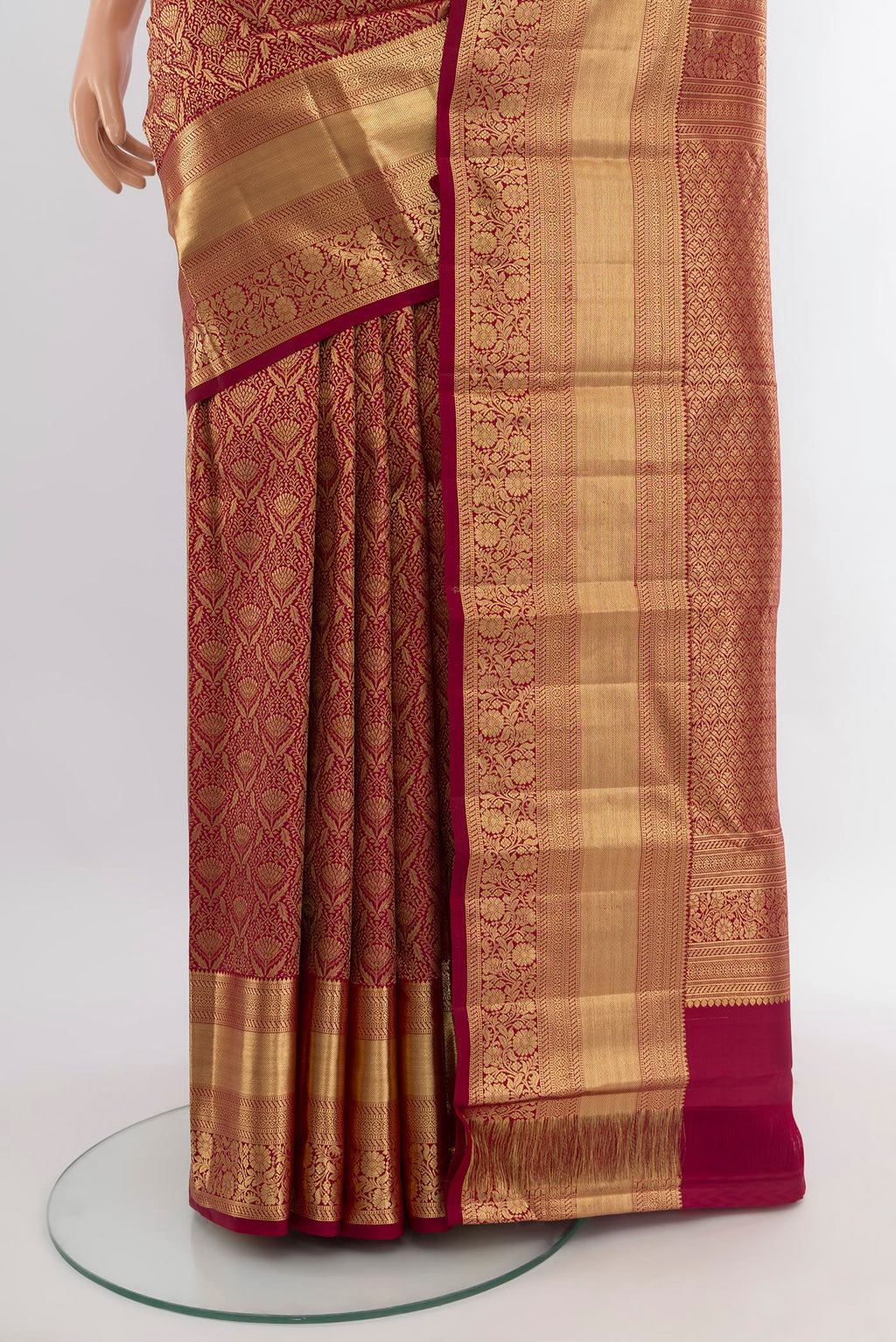Pleats and pallu of Maroon Kanchipuram Silk Saree with Zari Brocade on the body and Zari Border. 