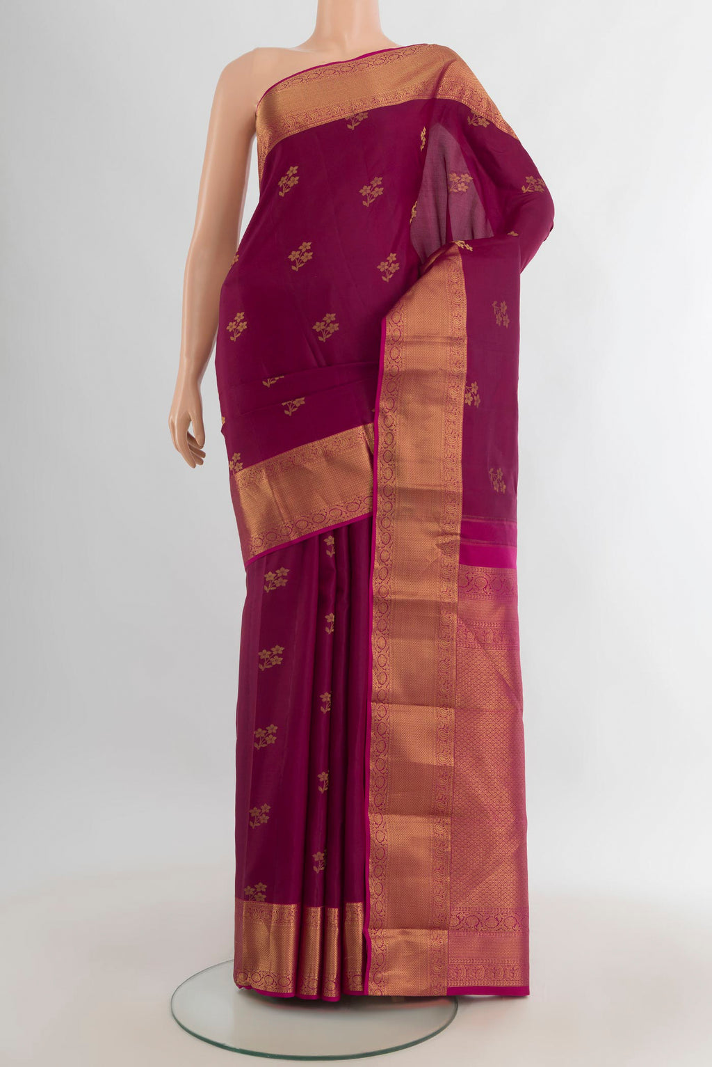 Pure Silk Maroon Kanjivaram Saree with Zari Butta on the body and Zari Border.  displayed on a mannequin