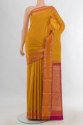 Pure Silk Mustard Kanchipuram Saree with Zari Butta on the body and Zari Border.  displayed on a mannequin