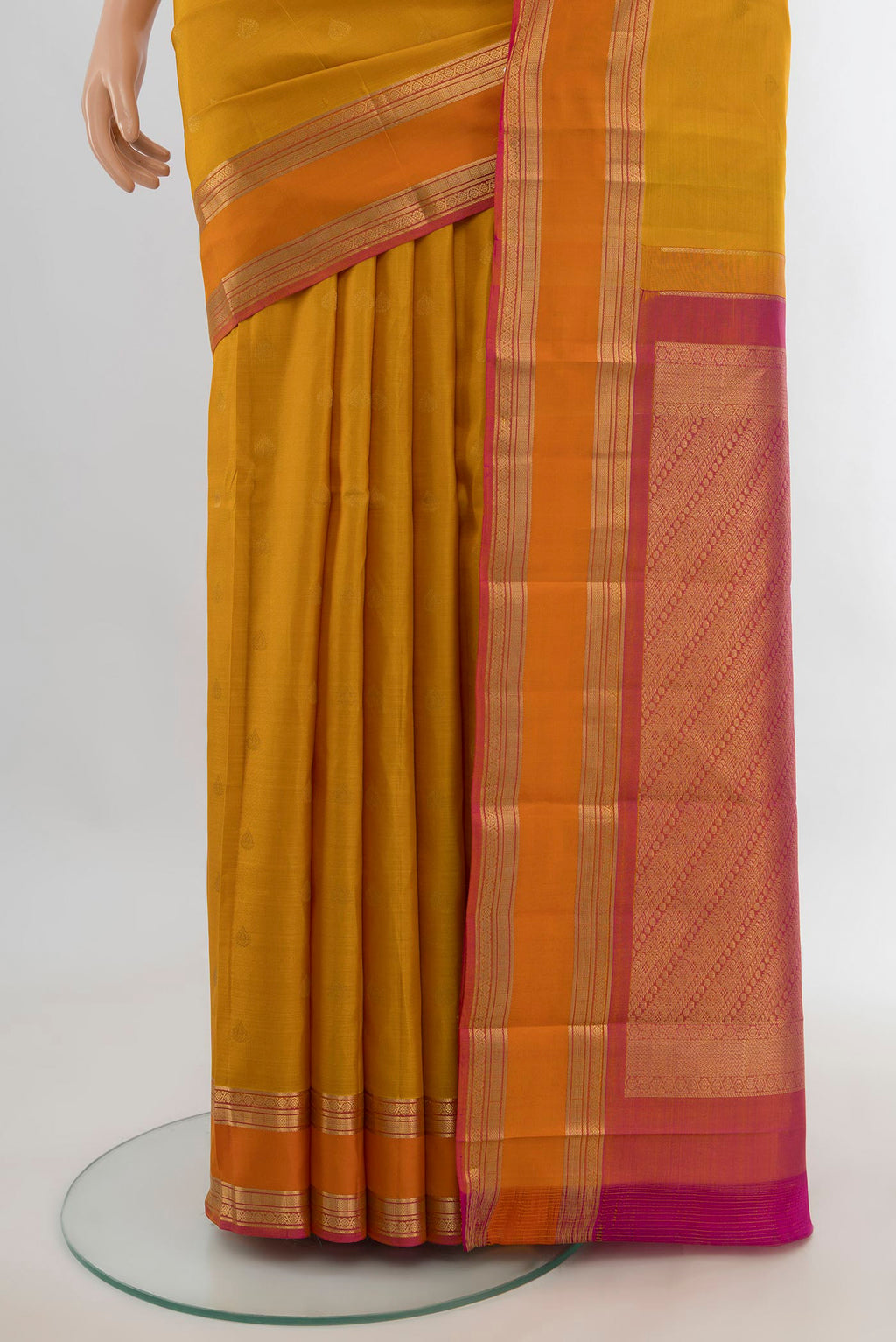Pleats and pallu of Pure Silk Mustard Kanchipuram Saree with Zari Butta on the body and Zari Border. 