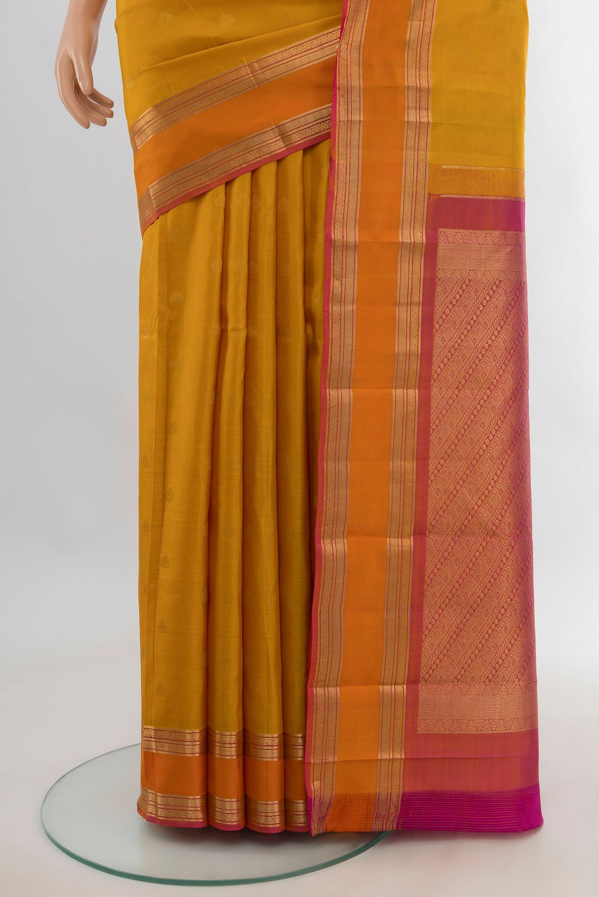 Pleats and pallu of Pure Silk Mustard Kanchipuram Saree with Zari Butta on the body and Zari Border. 