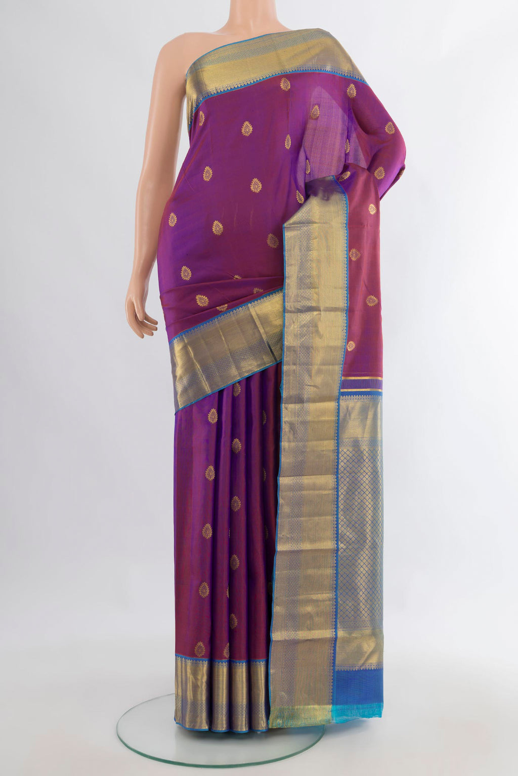 Pure Silk Purple Kanjivaram Saree with Zari Butta on the body and Zari Border.  displayed on a mannequin
