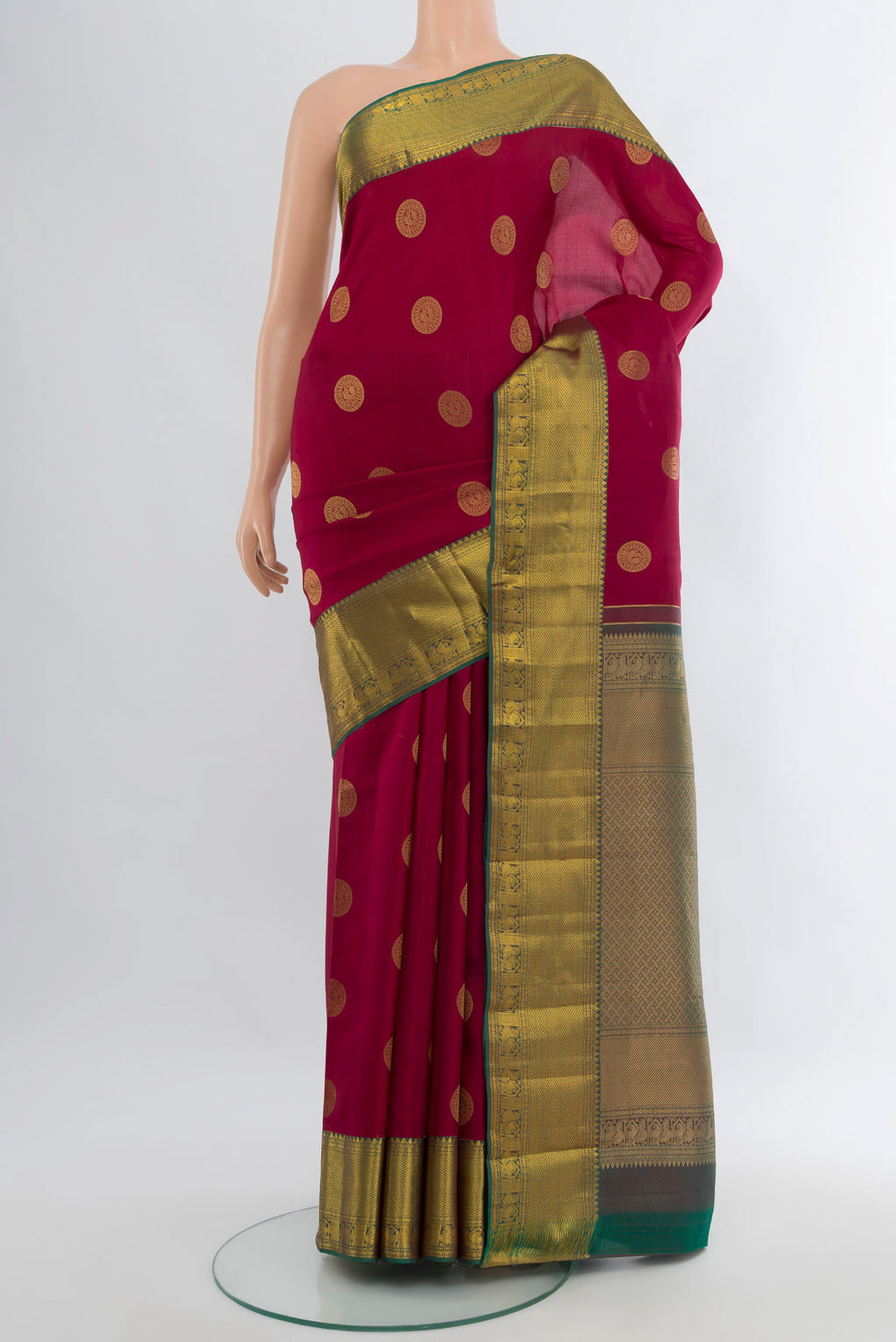 Maroon Kanjivaram Silk Saree with Zari Butta on the body and Zari Border.  displayed on a mannequin