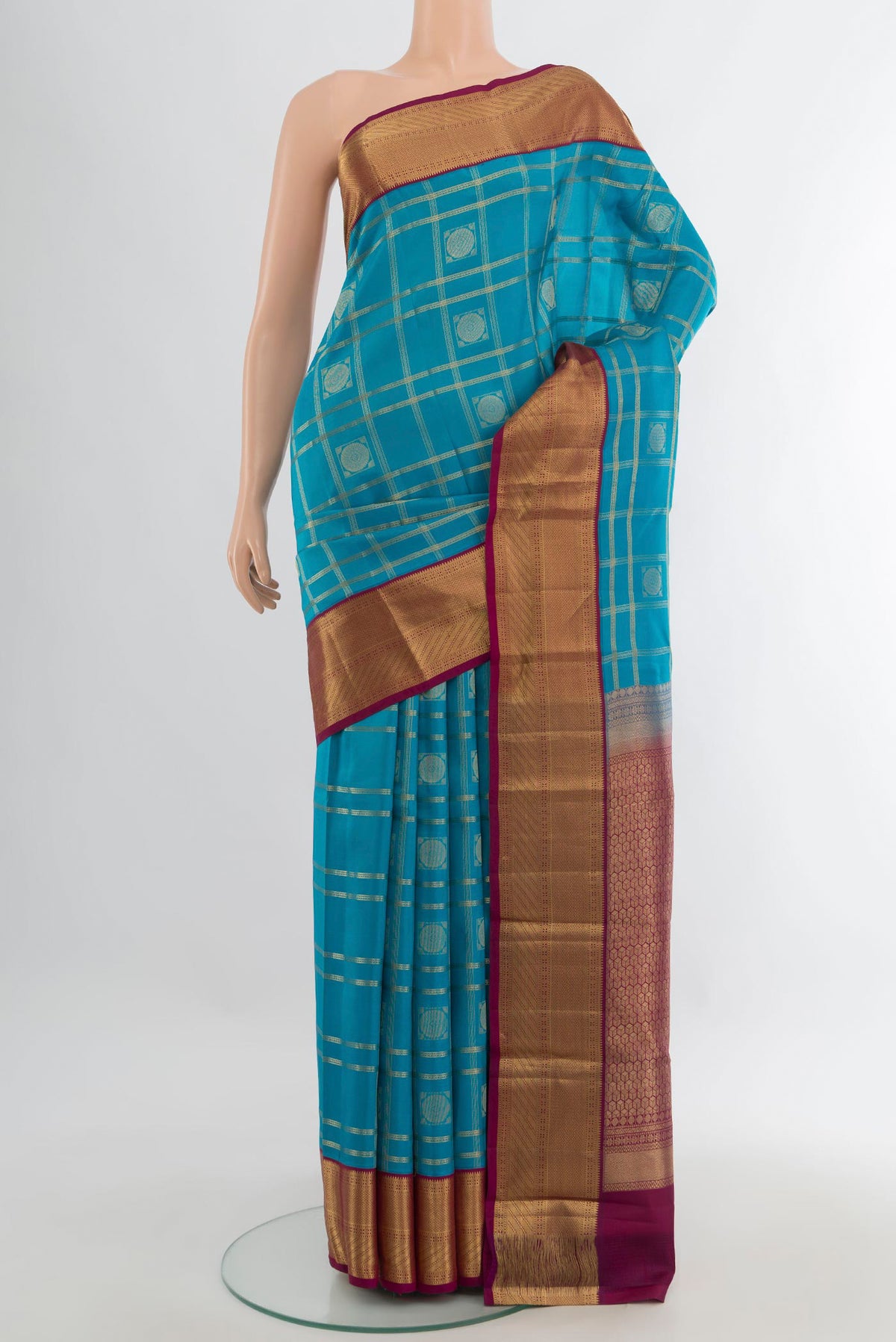 Pure Silk Light Blue Kanchipuram Saree with Checked design on the body and Zari Border.  displayed on a mannequin