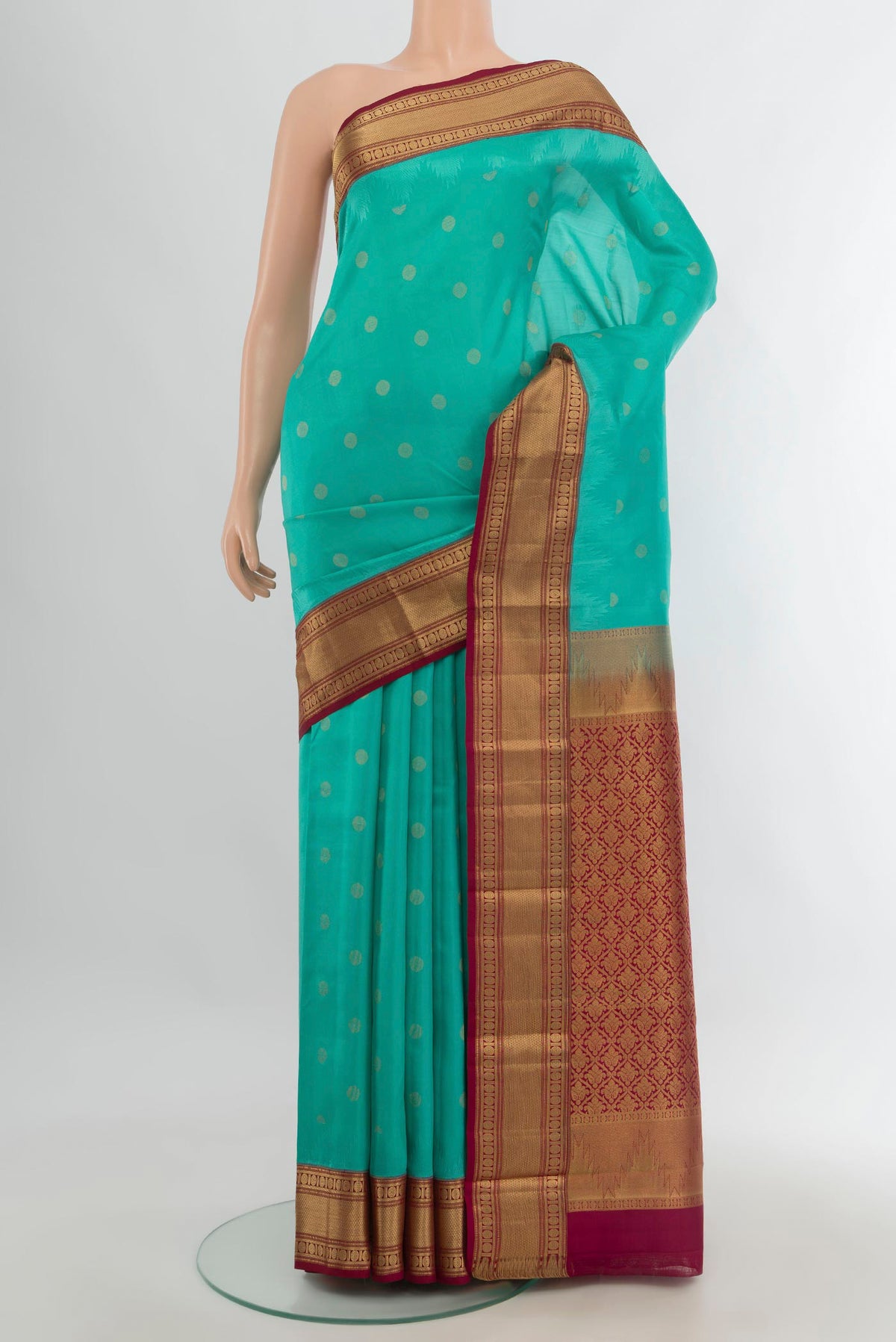 Pure Silk Sea Green Kanchipuram Saree with Zari Butta on the body and Zari Border.  displayed on a mannequin