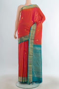 Pure Silk Peach Kanjivaram Saree with Zari Butta on the body and Silk Border.  displayed on a mannequin