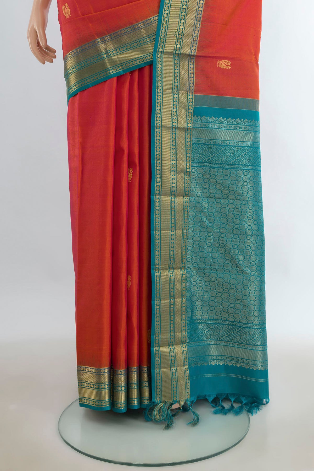 Pleats and pallu of Pure Silk Peach Kanjivaram Saree with Zari Butta on the body and Silk Border. 