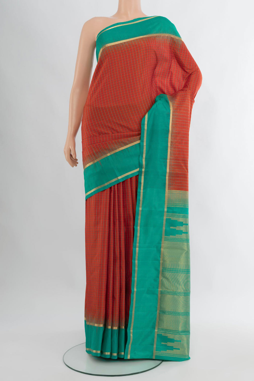 Rust Kanchipuram Silk Saree with Checked design on the body and Plain Border.  displayed on a mannequin