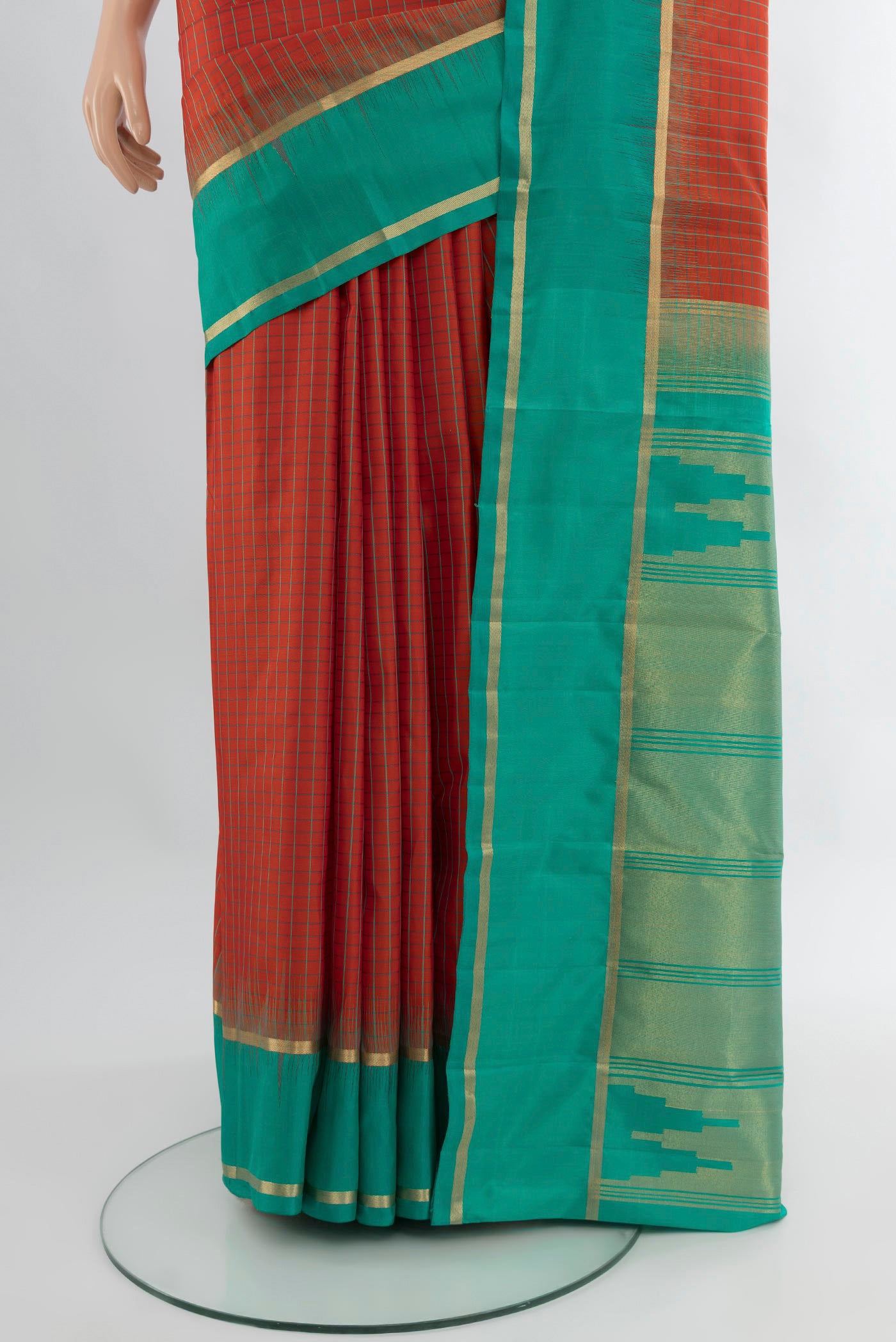 Pleats and pallu of Rust Kanchipuram Silk Saree with Checked design on the body and Plain Border. 