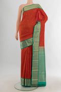 Pure Silk Orange Kanjivaram Saree with Zari Butta on the body and Zari Border.  displayed on a mannequin