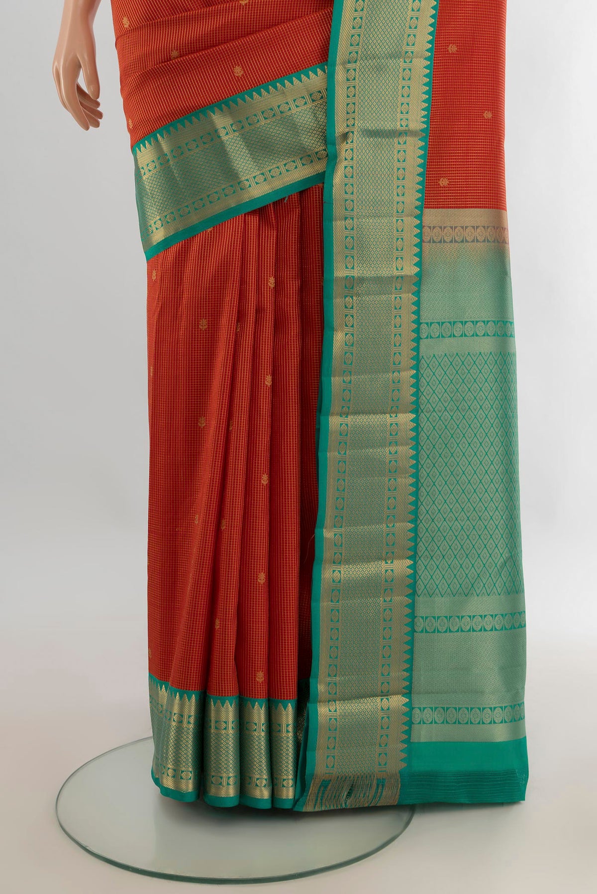 Pleats and pallu of Pure Silk Orange Kanjivaram Saree with Zari Butta on the body and Zari Border. 