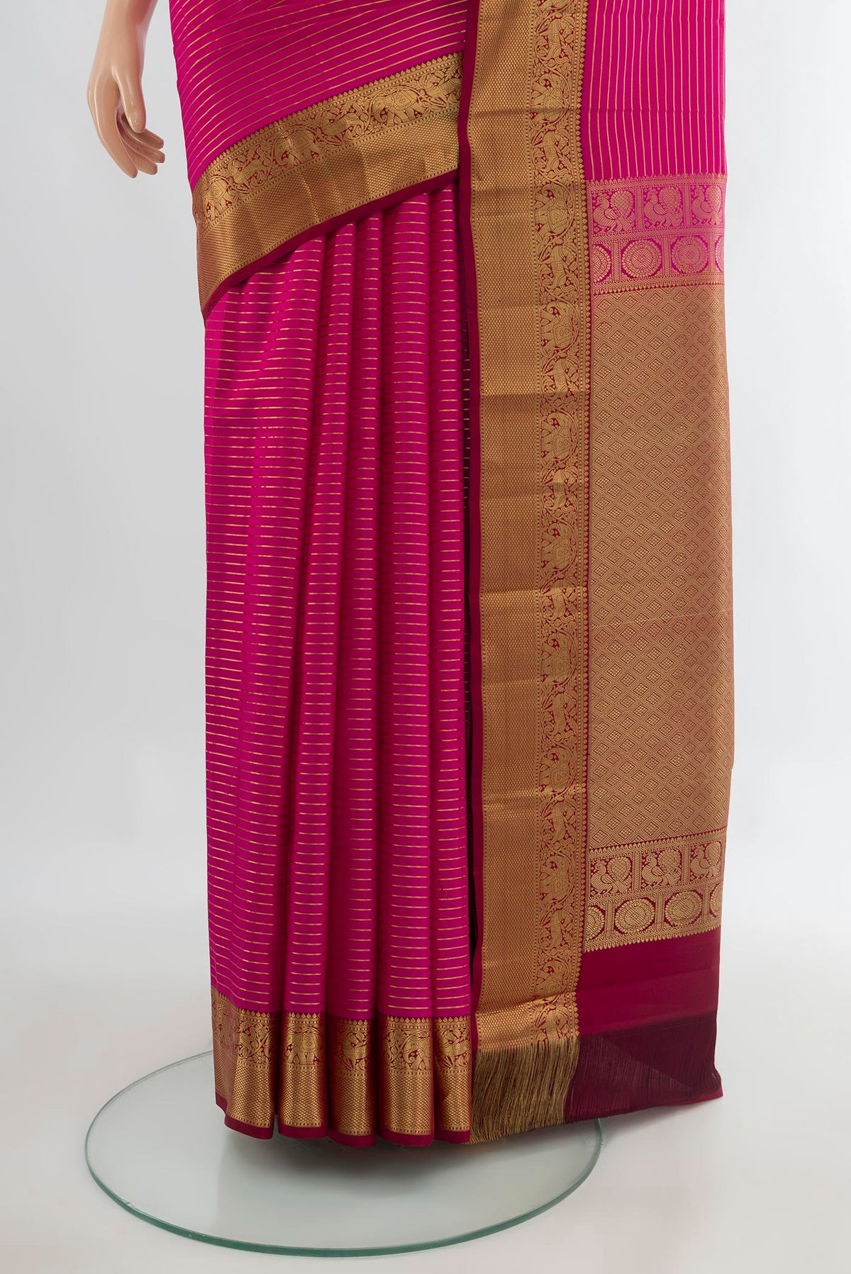 Pleats and pallu of Pure Silk Dark Pink Kanjivaram Saree with Stripes on the body and Zari Border. 