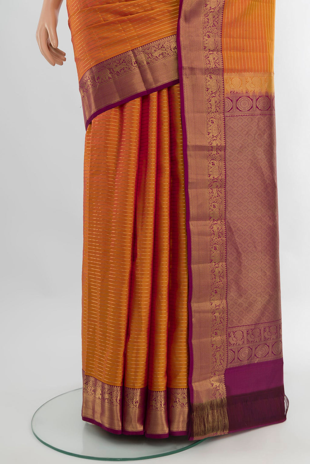 Pleats and pallu of Mustard Kanjivaram Silk Saree with Stripes on the body and Zari Border. 