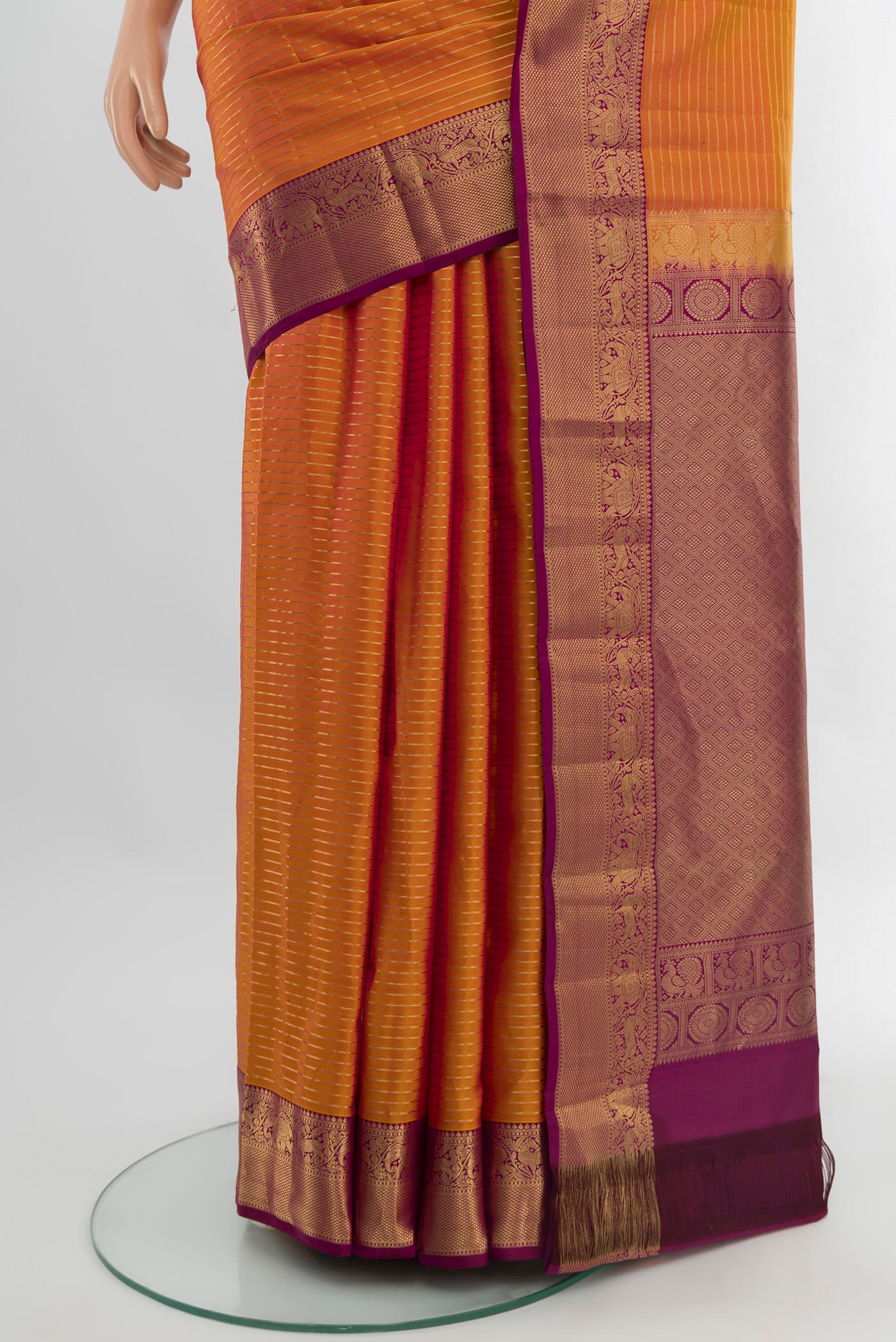 Pleats and pallu of Mustard Kanjivaram Silk Saree with Stripes on the body and Zari Border. 