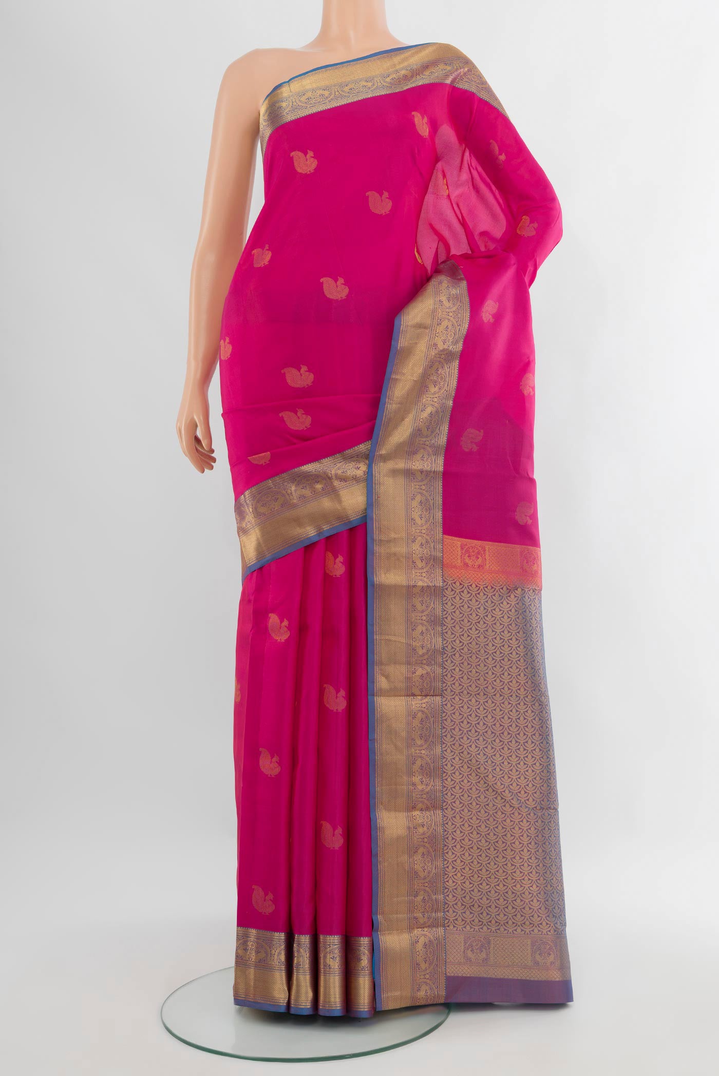 Pink Kanchipuram Silk Saree with Zari Butta on the body and Zari Border.  displayed on a mannequin