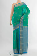 Green Dual Tone Kanchipuram Silk Saree with Zari Butta on the body and Zari Border.  displayed on a mannequin