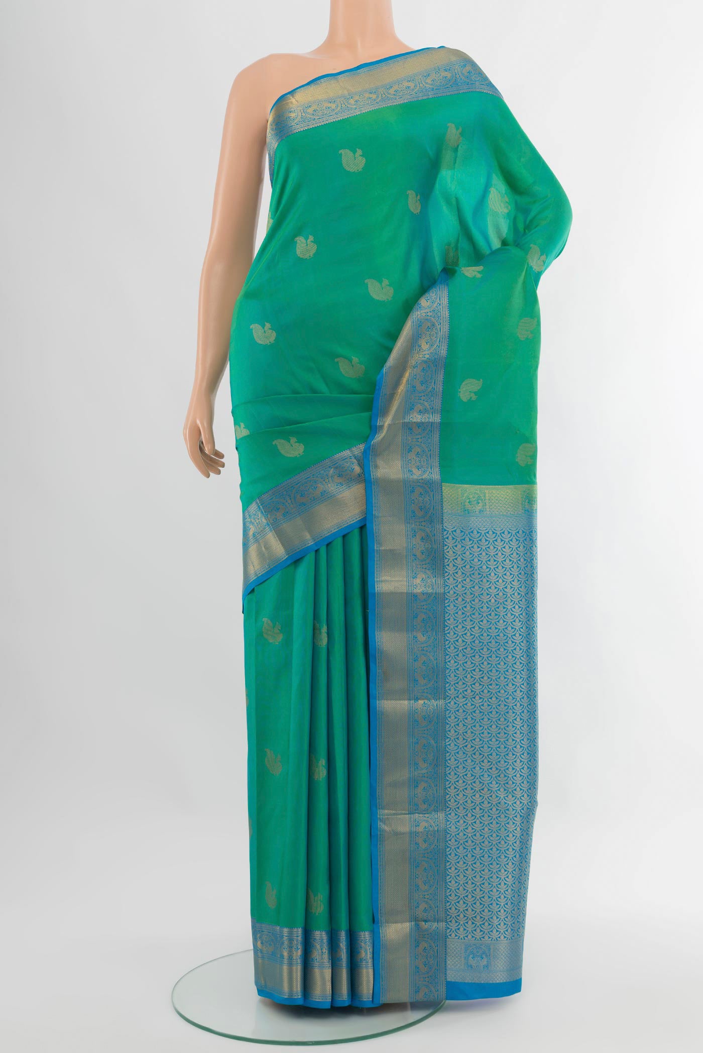 Green Dual Tone Kanchipuram Silk Saree with Zari Butta on the body and Zari Border.  displayed on a mannequin