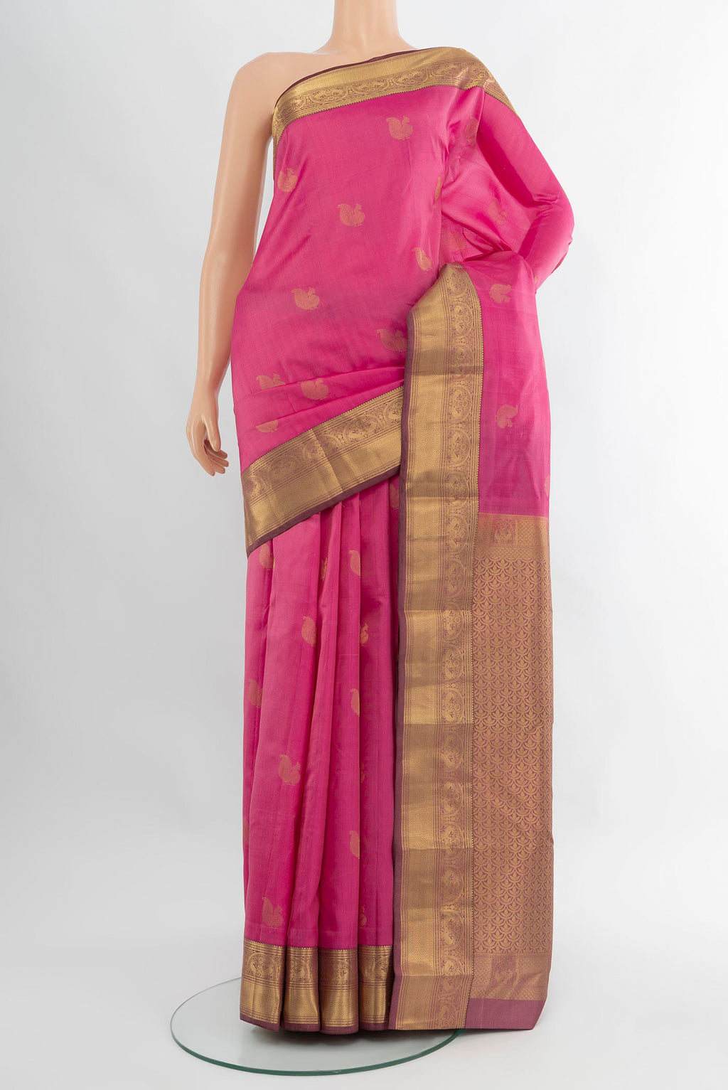 Rose pink Kanchipuram Silk Saree with Zari Butta on the body and Zari Border.  displayed on a mannequin