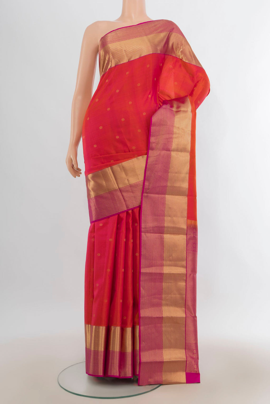 Pure Silk Brick Orange Kanchipuram Saree with Zari Butta on the body and Zari Border.  displayed on a mannequin