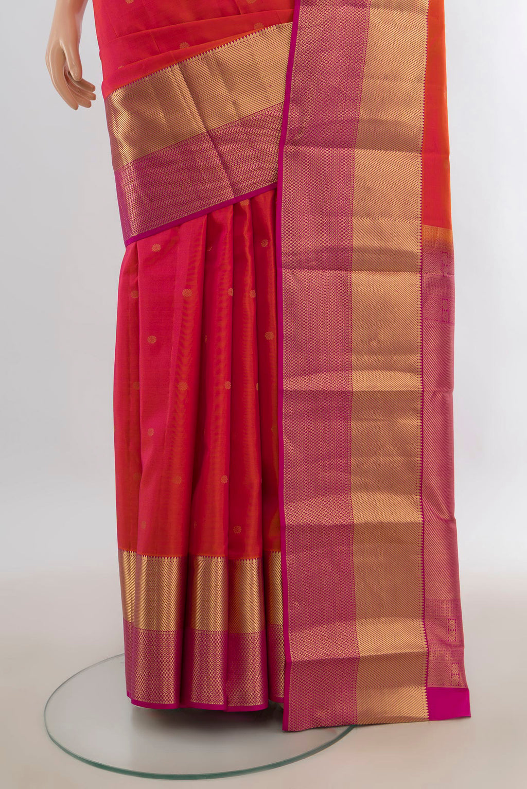 Pleats and pallu of Pure Silk Brick Orange Kanchipuram Saree with Zari Butta on the body and Zari Border. 
