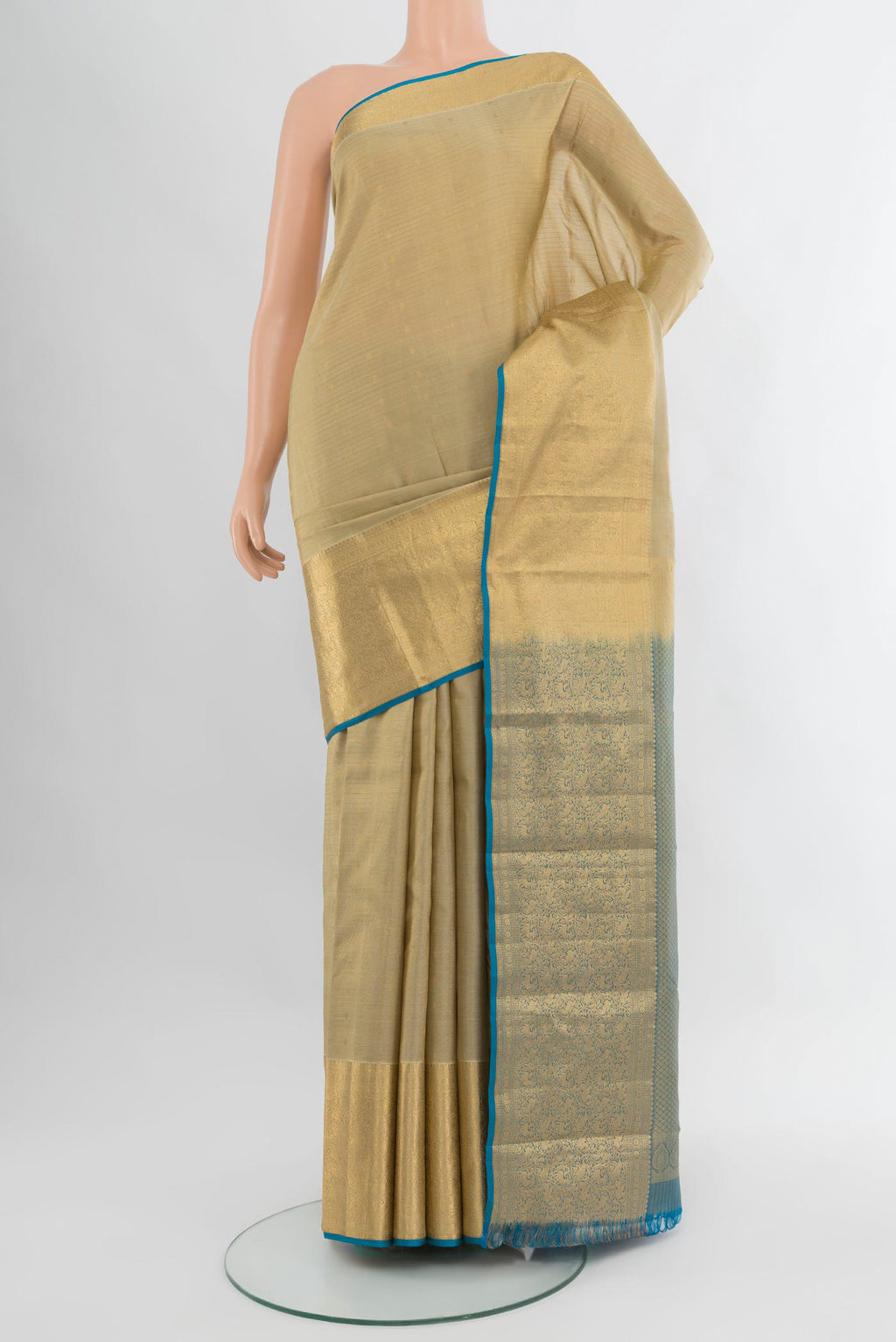 Beige Kanjivaram Silk Saree with Zari Butta on the body and Zari Border.  displayed on a mannequin