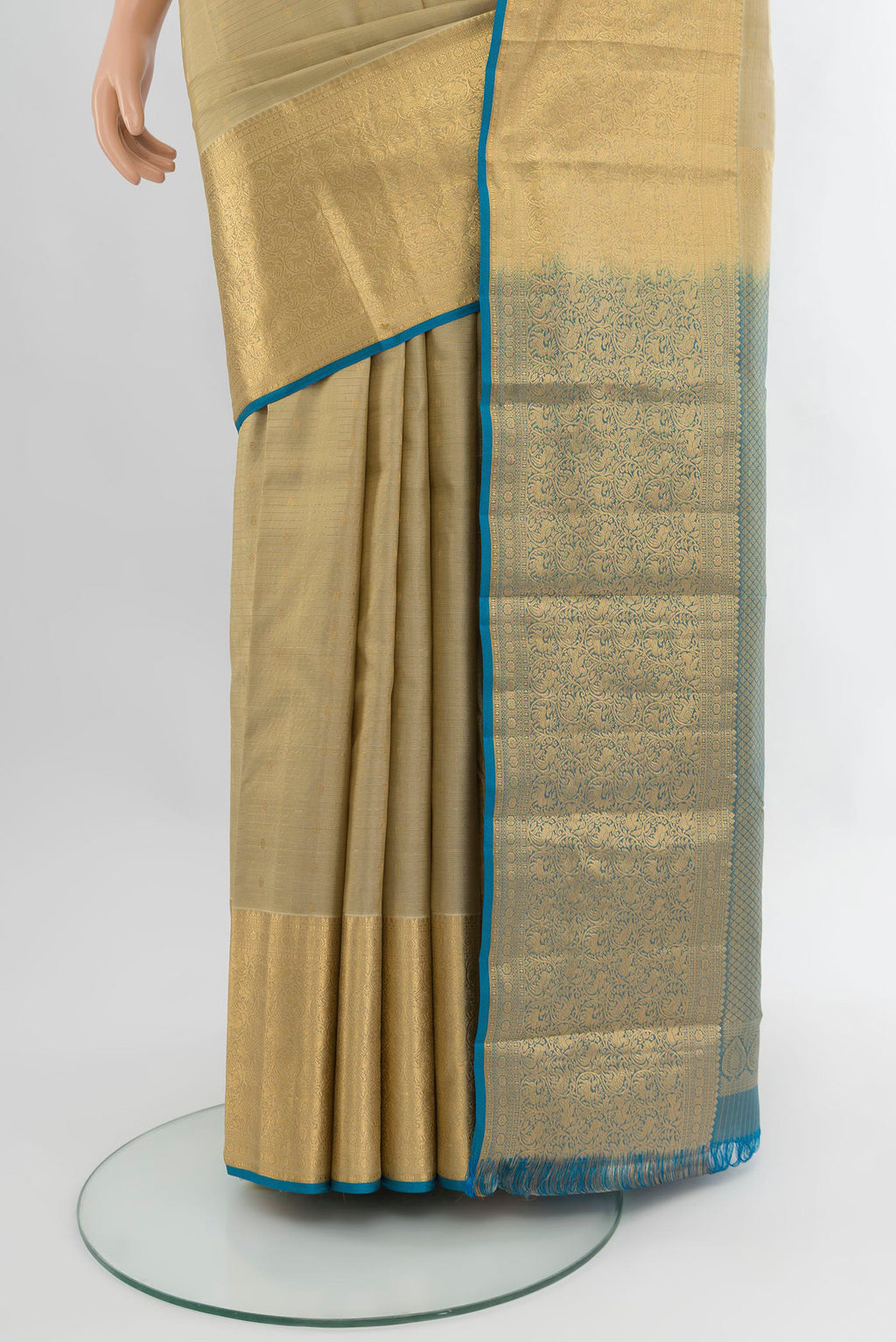 Pleats and pallu of Beige Kanjivaram Silk Saree with Zari Butta on the body and Zari Border. 