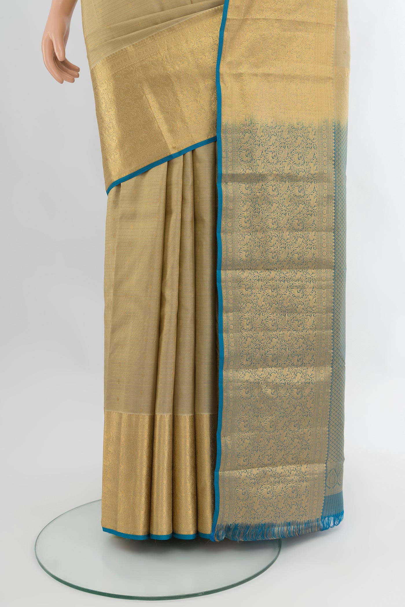Pleats and pallu of Beige Kanjivaram Silk Saree with Zari Butta on the body and Zari Border. 