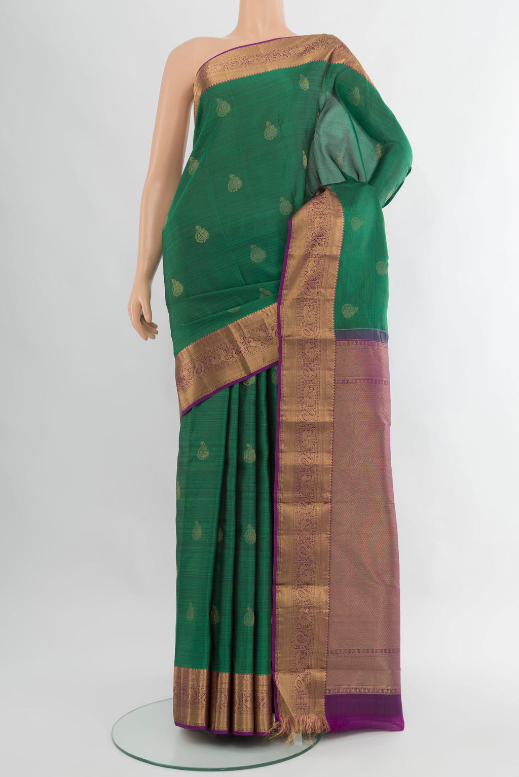 Green Kanchipuram Silk Saree with Zari Butta on the body and Zari Border.  displayed on a mannequin