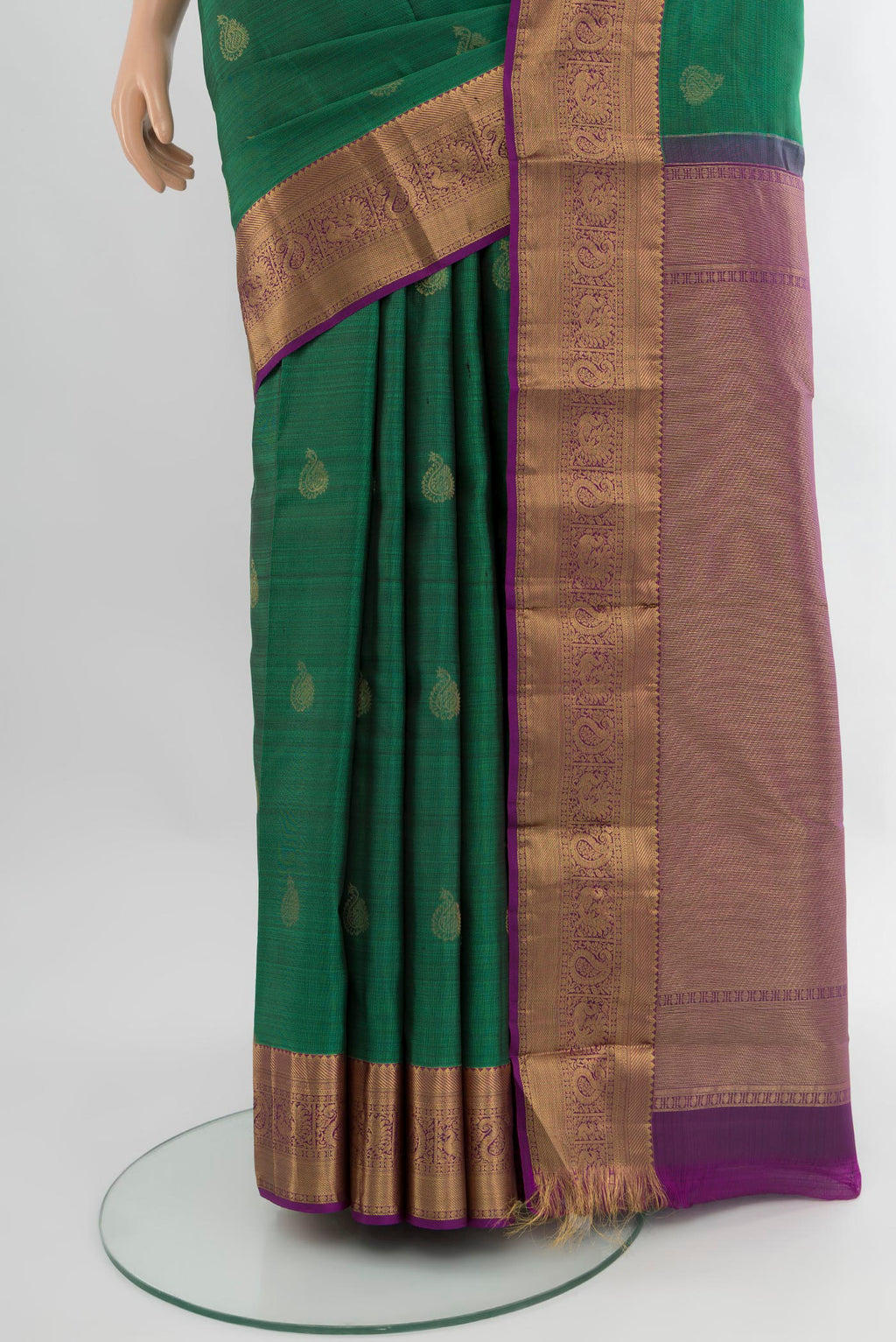 Pleats and pallu of Green Kanchipuram Silk Saree with Zari Butta on the body and Zari Border. 