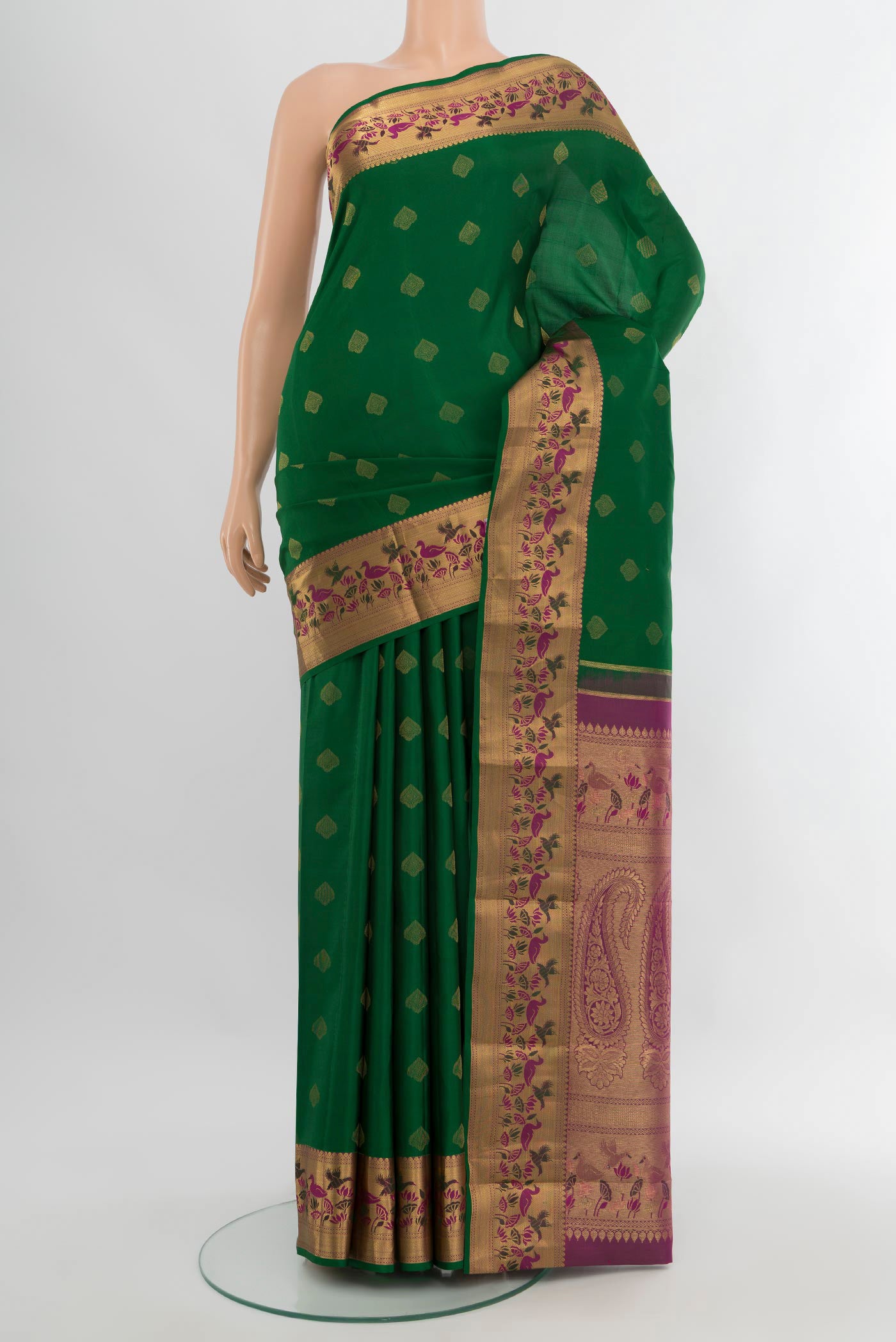 Bottle Green Kanjivaram Silk Saree with Zari Butta on the body and Zari Border.  displayed on a mannequin