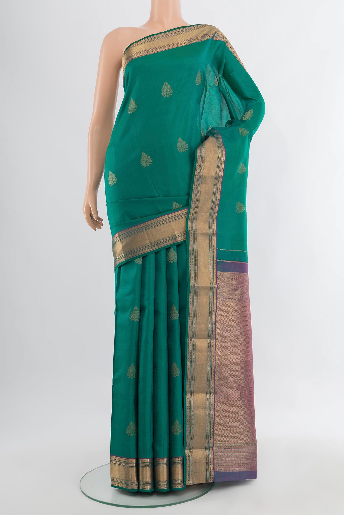 Peacock Blue Kanchipuram Silk Saree with Zari Butta on the body and Silk Border.  displayed on a mannequin