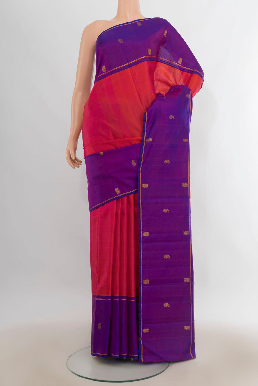 Pure Silk Brick Orange Kanjivaram Saree with Plain Body and Zari Border.  displayed on a mannequin
