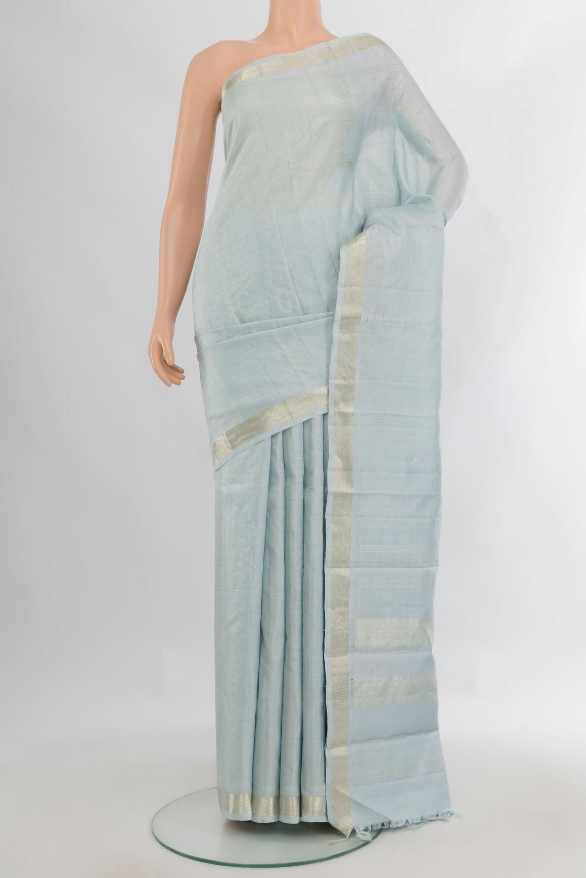 Pure Silk Light Blue Kanjivaram Saree with Checked design on the body and Zari Border.  displayed on a mannequin