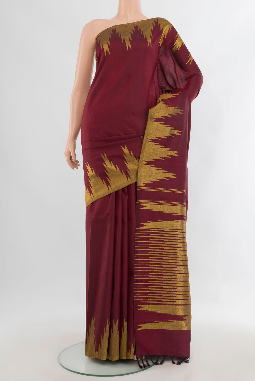 Pure Silk Maroon Kanjivaram Saree with Plain Body and Temple Border.  displayed on a mannequin