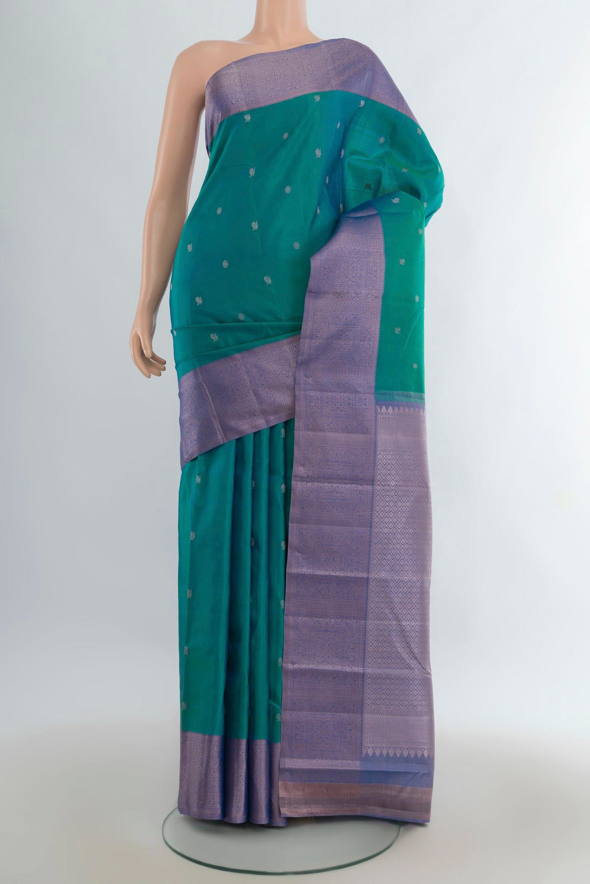 Pure Silk Sea Green Kanchipuram Saree with Thread Butta on the body and Thread Border.  displayed on a mannequin