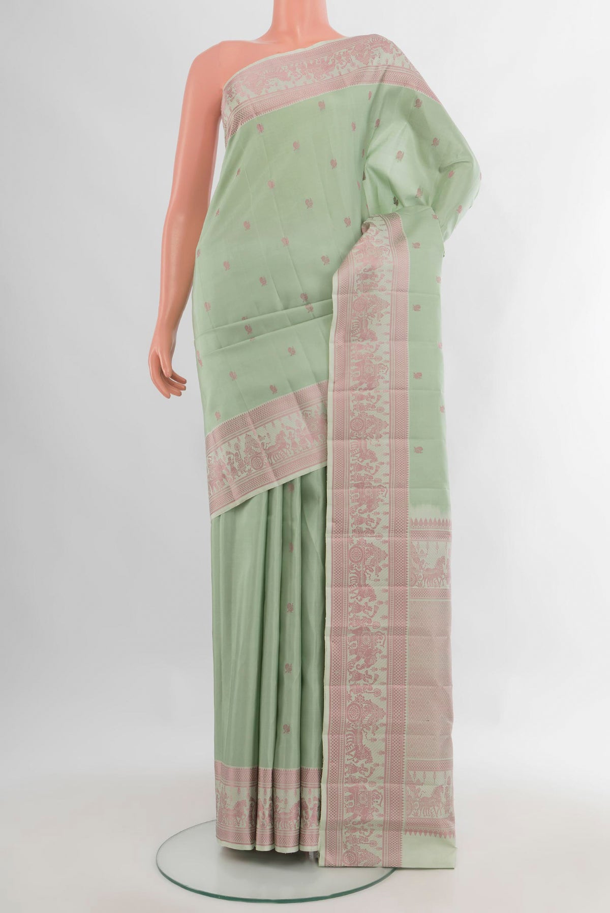 Pure Silk Pista Green Kanchipuram Saree with Thread Butta on the body and Thread Border.  displayed on a mannequin