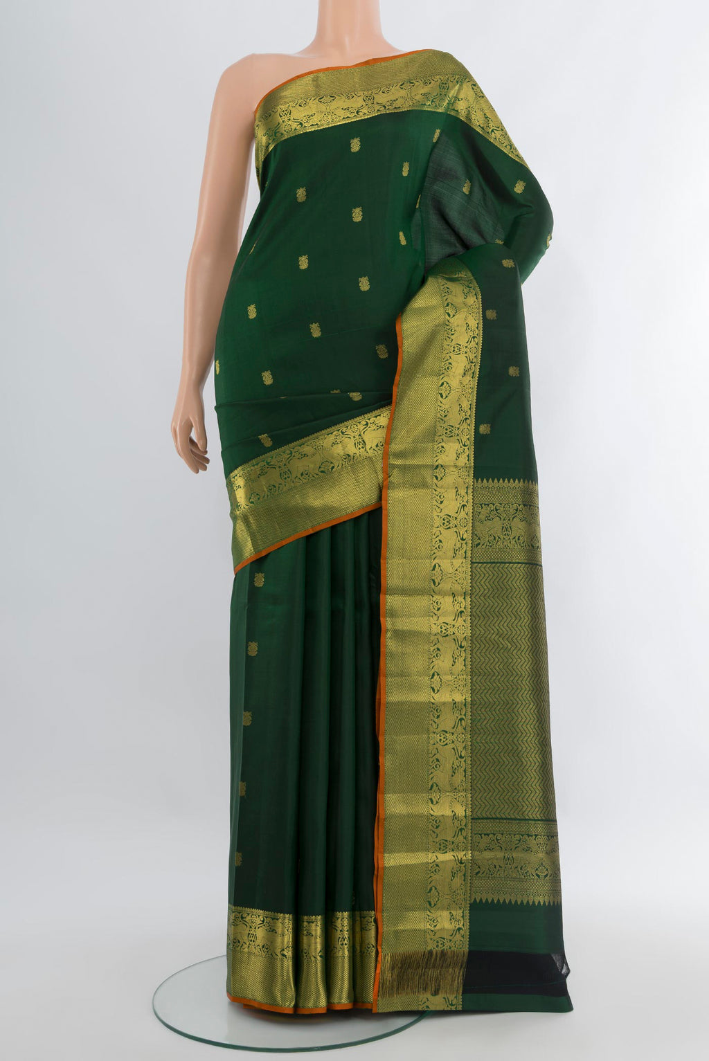 Bottle Green Kanchipuram Silk Saree with Zari Butta on the body and Zari Border.  displayed on a mannequin