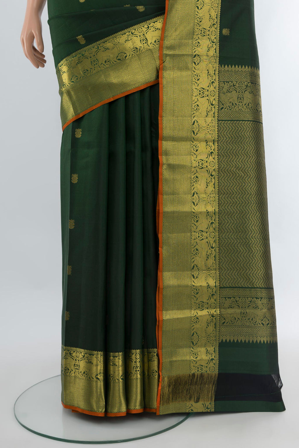 Pleats and pallu of Bottle Green Kanchipuram Silk Saree with Zari Butta on the body and Zari Border. 
