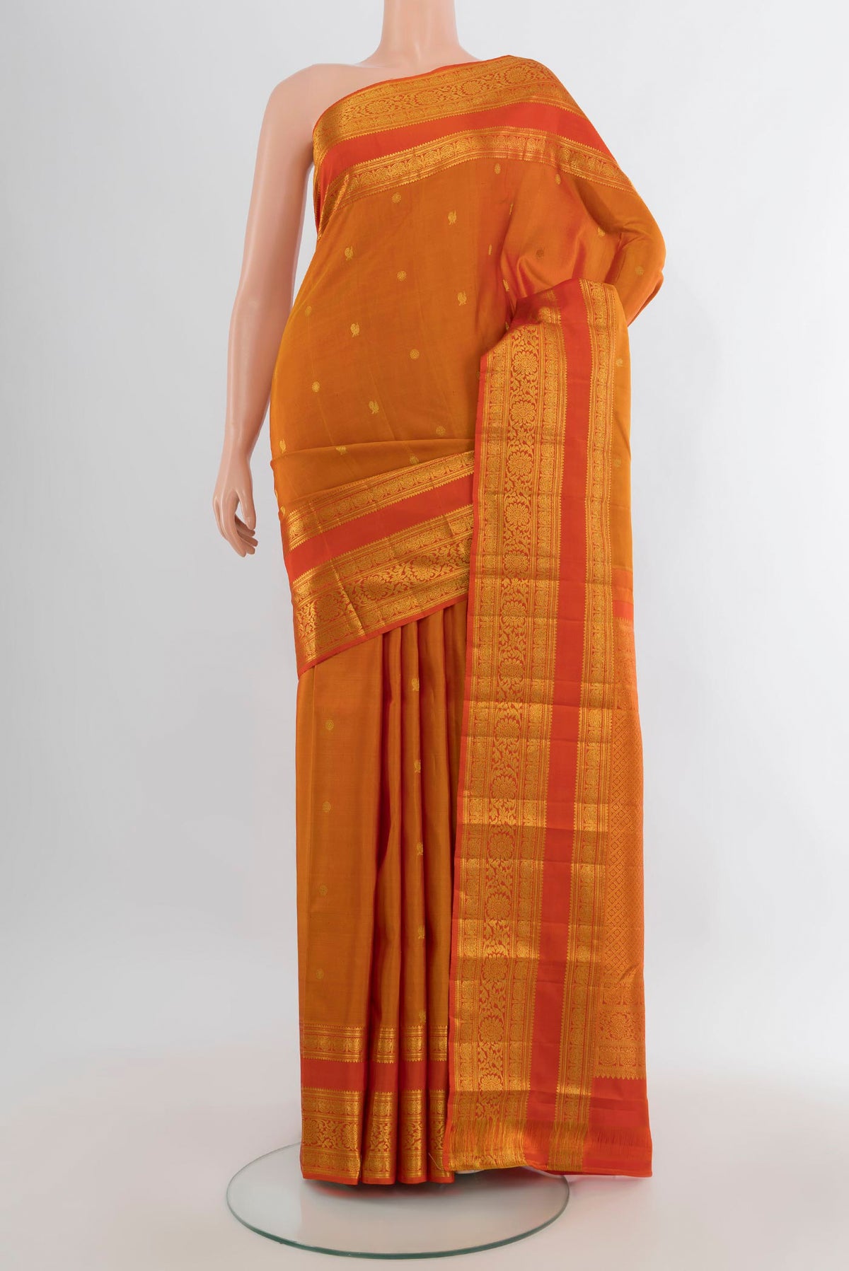 Pure Silk Mustard Kanchipuram Saree with Zari Butta on the body and Zari Border.  displayed on a mannequin