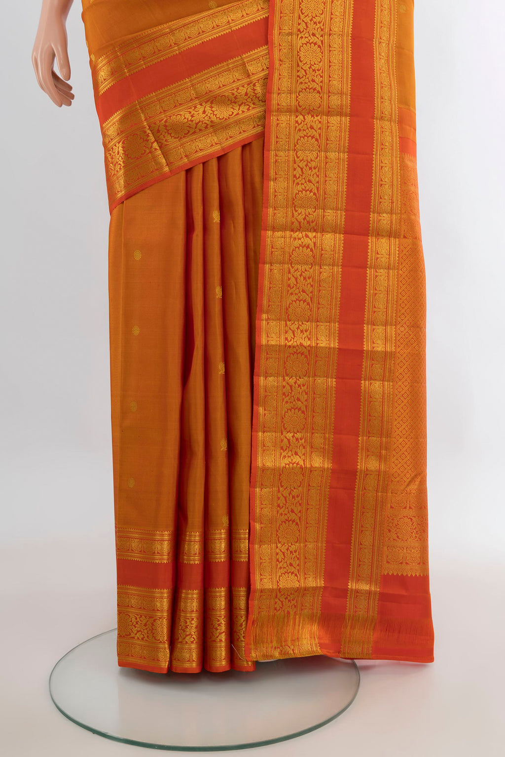 Pleats and pallu of Pure Silk Mustard Kanchipuram Saree with Zari Butta on the body and Zari Border. 