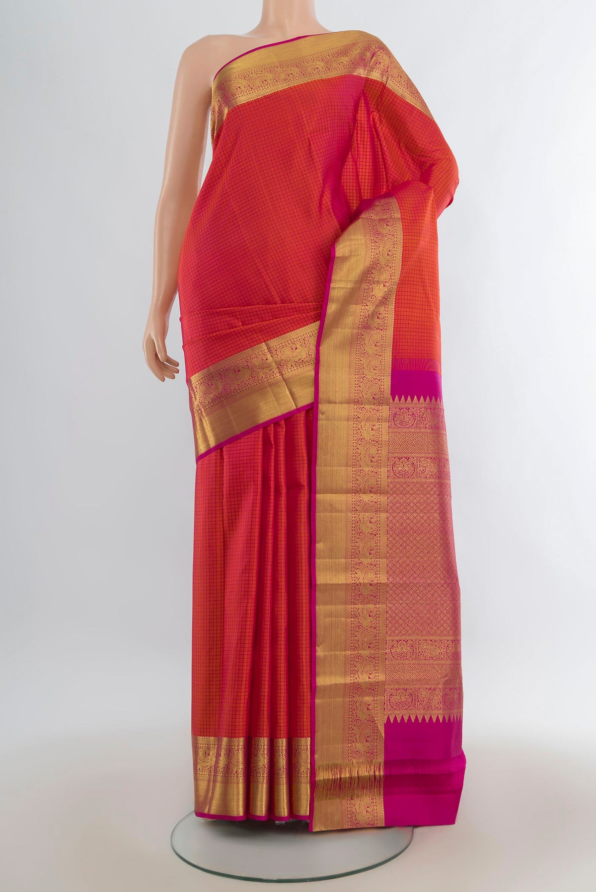 Pure Silk Orange Kanjivaram Saree with Checked design on the body and Zari Border.  displayed on a mannequin