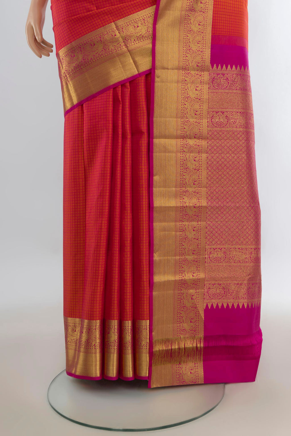 Pleats and pallu of Pure Silk Orange Kanjivaram Saree with Checked design on the body and Zari Border. 