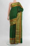 Bottle Green Kanjivaram Silk Saree with Checked design on the body and Zari Border.  displayed on a mannequin