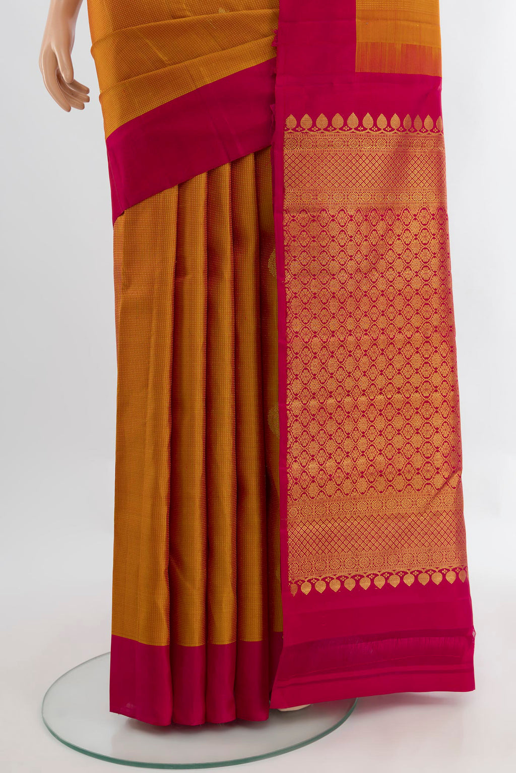 Pleats and pallu of Mustard Kanjivaram Silk Saree with Zari Butta on the body and Silk Border. 